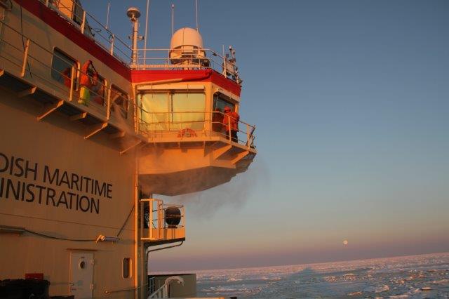 Cleaning bridge windows in sunset with moon in the back. Cleaning bridge windows in sunset with moon in the back.