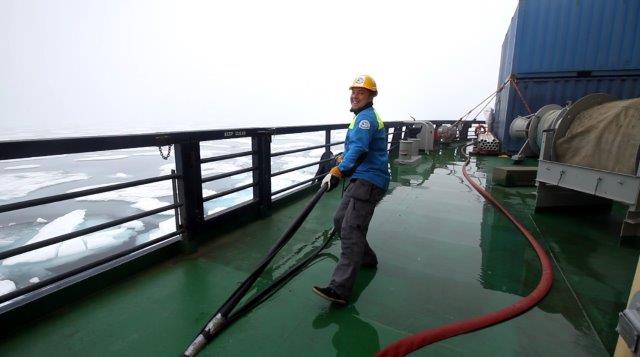 Sasha pulling hose at starboard.